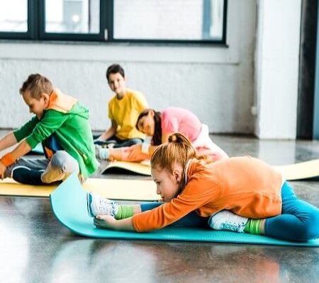 Group-of-kids-stretching-on-colorful-fitness-mats (1)